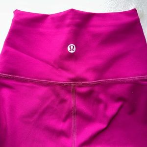 Bright pink Lululemon wonder train leggings